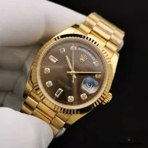 Angled shot of chocolate dial against yellow gold-plated President bracelet