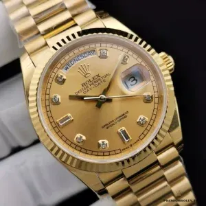 Day window at twelve o'clock with weekday text on gold face