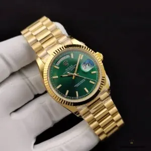 Green dial macro with uniform sunburst pattern and applied gold indices