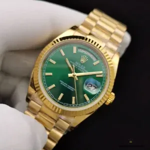 Angled shot of green dial reflecting light under fluted bezel