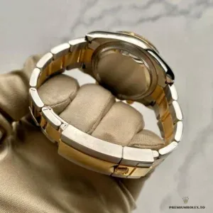 Diamond markers catching light against the lacquered black dial surface