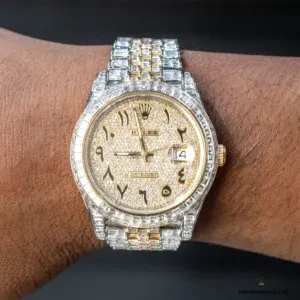 Side profile of 126300 showing yellow gold-plated bezel accents on Oystersteel case