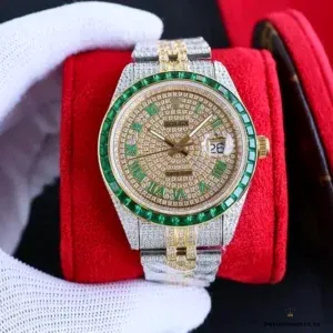 Close-up of yellow gold stick indices against paved diamond dial on 126300