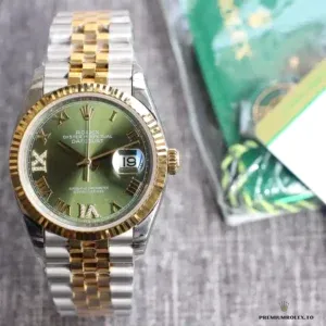 Angled view showing two-tone gold and steel case with green dial