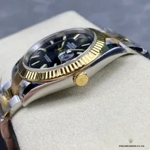 Close-up of bright black dial with gold applied indices