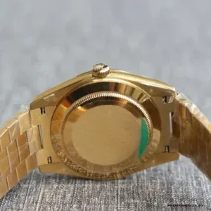 Close-up of black motif dial texture with gold applied hour markers