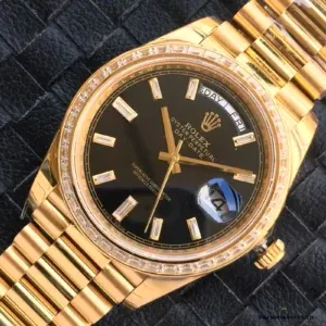 Close-up of black dial with diamond markers and day display