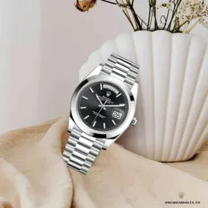 Close-up of black dial showing applied markers and day window