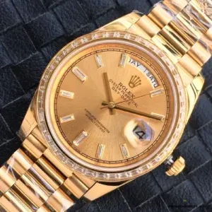 Close-up of gold dial with gem-set hour markers and day window