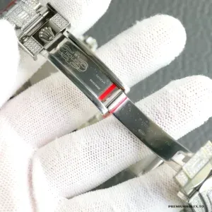 Overhead angle of complete watch showing diamond and green stone layout