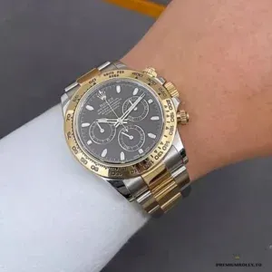 Close-up of gold tachymeter bezel and black chronograph dial