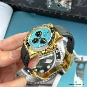 Yellow gold applied hour markers against turquoise dial surface