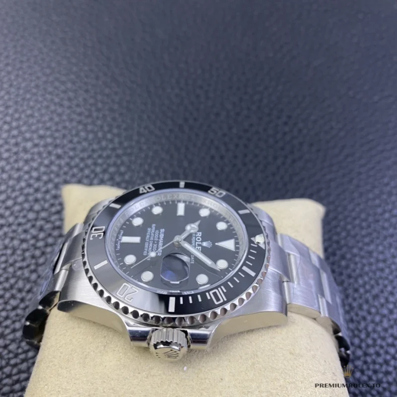 Black Submariner 116610LN on a watch cushion, seen from the crown side