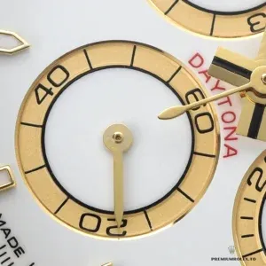 Crown and chronograph pushers on the yellow gold Daytona