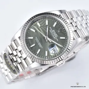 Close-up of vertical fluted ridges on the mint green dial surface