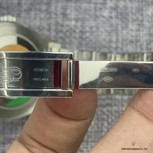 Close-up of mint green dial with luminescent stick markers and date window