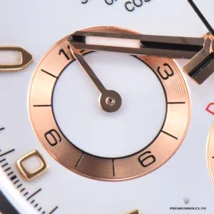 Close-up of white dial with pink-toned chronograph subdials