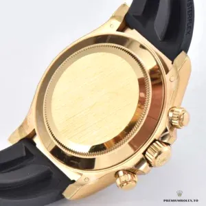 Close-up of bright black dial with diamond markers on gold Daytona