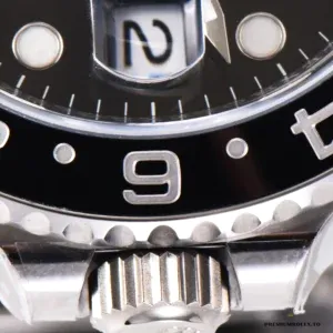 Macro of the screw-down crown between the crown guards on a GMT-Master II 116710LN