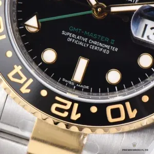 GMT-Master 116713LN side profile showing black Cerachrom bezel and gold-plated crown