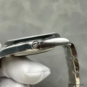 Oyster Perpetual 124300 green dial at angle showing lacquer depth and shine