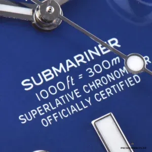 Close-up of blue dial with applied markers and date at three