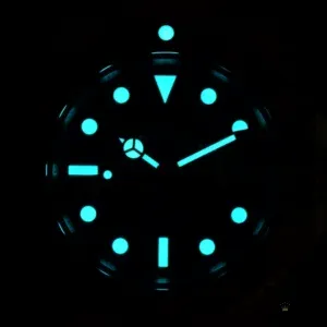 Submariner 126613LB photographed in the dark with the hands, hour markers and bezel pip glowing blue