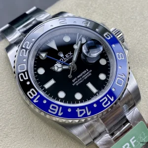Black dial detail with green GMT triangle hand and Maxi markers
