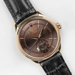 Applied Everose gold indices on brown dial surface