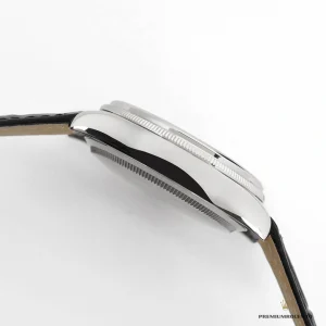 Black guilloche pattern detail under white gold-plated bezel