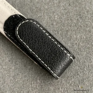 Red-tipped GMT hand detail over black dial with white indices