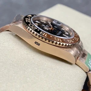 Rootbeer GMT-Master lume shot showing warm gold indices glow