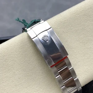 Close-up of electric blue sunburst dial with orange hour markers