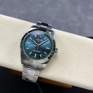 Green-tinted crystal edge visible at an angle on blue dial Milgauss