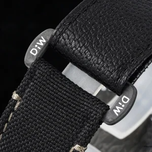Close-up of carbon bezel texture and luminous pip at twelve