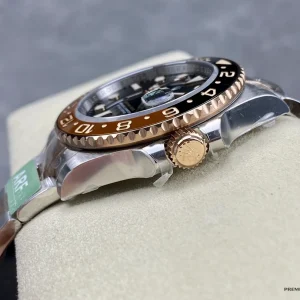 Replica Rolex GMT-Master II Root Beer side profile with Everose gold-plated crown and guards