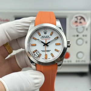 Close-up of 116400 dial showing applied luminescent markers and orange hand