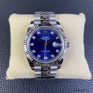 Angled view of blue sunburst dial showing diamond hour markers reflection
