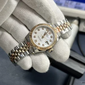 Close-up of mother of pearl dial with warm rose gold reflections