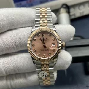 Close-up of pink dial with diamond hour markers on the 278271