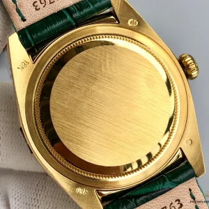 Close-up of green sunburst dial with applied gold hour markers
