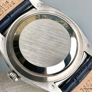 Close-up of silver sunburst dial with applied stick indices