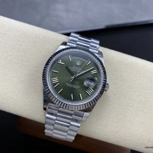 Close-up of olive green dial texture and applied hour markers