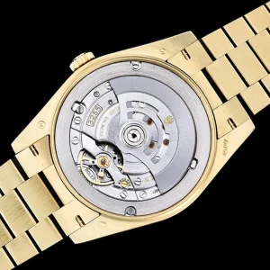 Day-Date M228238 dial close-up with applied gold hour markers and day window at 12