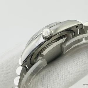 Replica Rolex Day-Date 228239AF angled view highlighting platinum-tone fluted bezel reflections