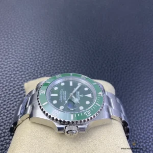 Submariner 116610LV with green dial and green bezel, side view from the crown on a watch cushion