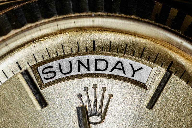 Rolex Day-Date day wheel showing SUNDAY text at 12 o'clock position close-up
