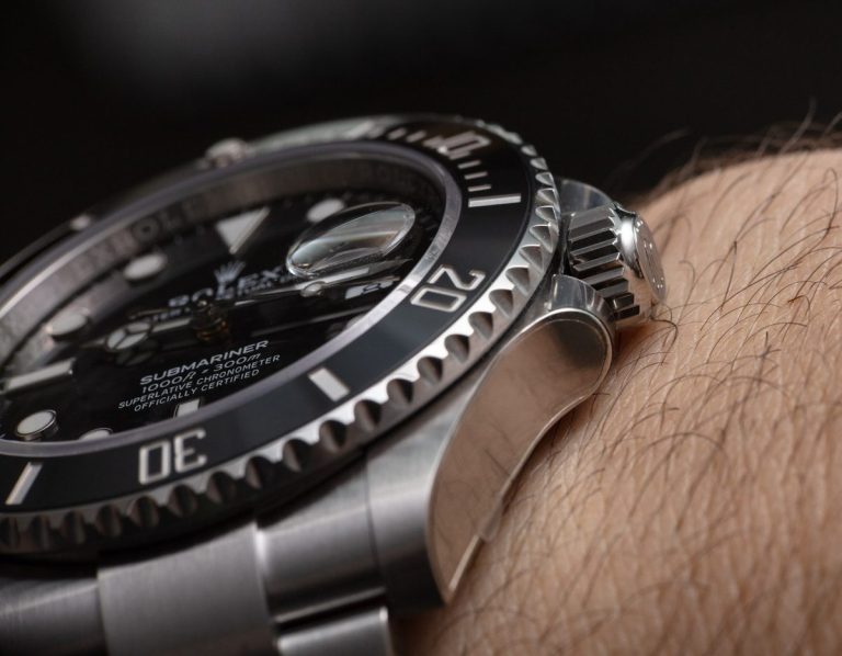 Rolex Submariner 126610LN close-up showing black ceramic bezel crown and oyster bracelet on wrist