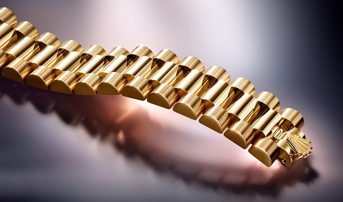 Gold Rolex President bracelet macro showing brushed and polished link alternation