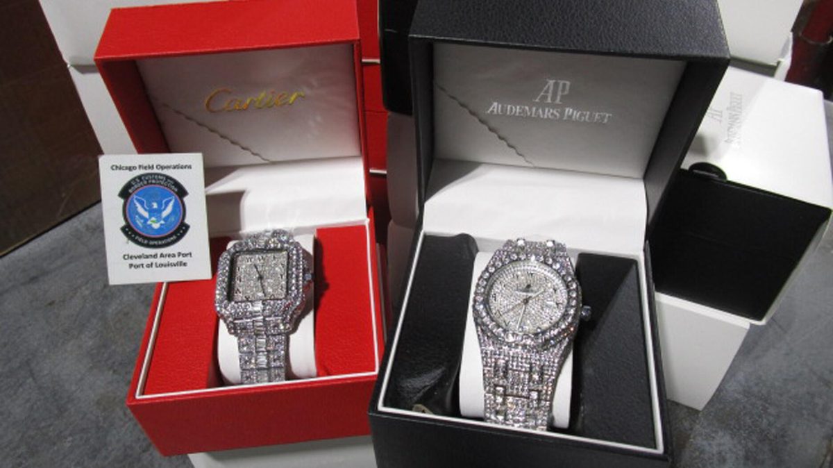 Seized counterfeit luxury watches at customs showing confiscation process
